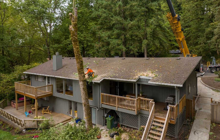 ArborPro using a crane to remove a tree very close to a home near Portland, Oregon.